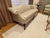 An elegant 18th-century revival Chippendale camelback sofa featuring a gracefully arched crest rail, flared outscrolled...