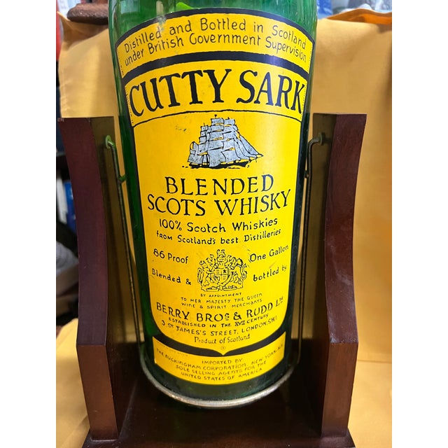 Add an authentic splash of mid-century bar car culture to your space with this vintage 1-gallon Cutty Sark Blended Scots...