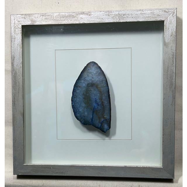 Two handpicked segments of Blue Agate Gemstones framed in wood behind glass. Dimensions: 10.5" wide x 10.5" wide x 1" deep...