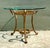 This stunning vintage drinks table is a quintessential example of Hollywood Regency glamour, blending classical motifs...