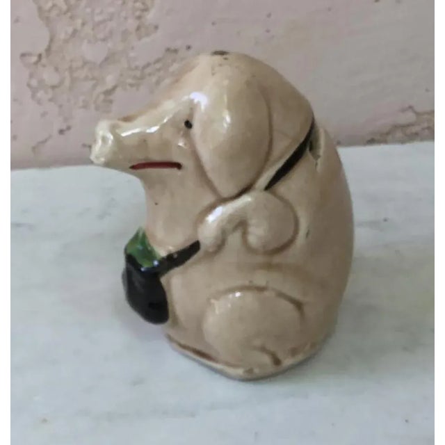 French Majolica money bank pig with a bag Orchies circa 1900. Small hairline and bubbles on the glaze.