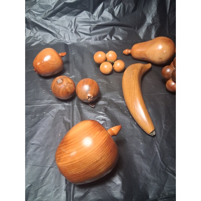 Unique carved wood pieces of fruit consisting of a banana, a large & small apple, pear, lemon, grapes & a couple more,...