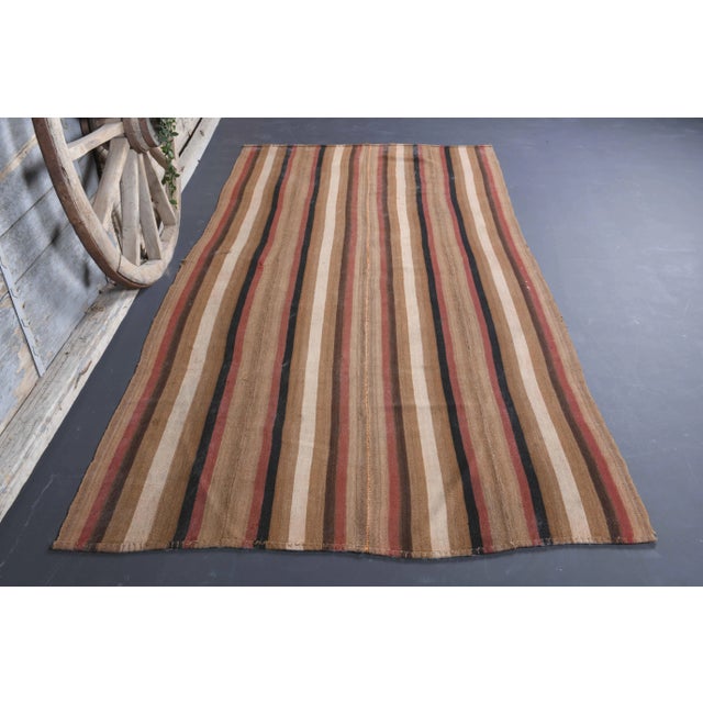 Vintage Turkish Hand-Knotted vintage rug is a semi-Vintage kilim runner rug.'70s Eastern region of Turkey's unique rug is...