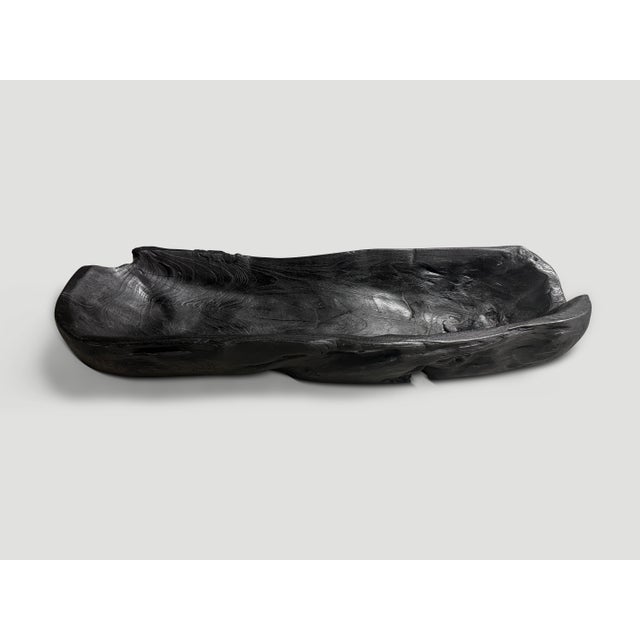 Impressive long charred vessel hand carved from a single piece of reclaimed teak wood. Both usable and sculptural. Charred...