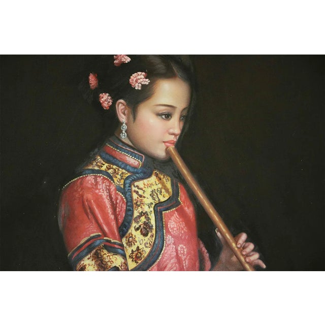 Oil painting on canvas of a Chinese female musician playing flute. This is a replica of an oil painting by Chen Yifei...