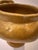 A vintage ceramic vessel with a classic urn-like silhouette, a rounded, footed base tapering up into a wide, flared body....