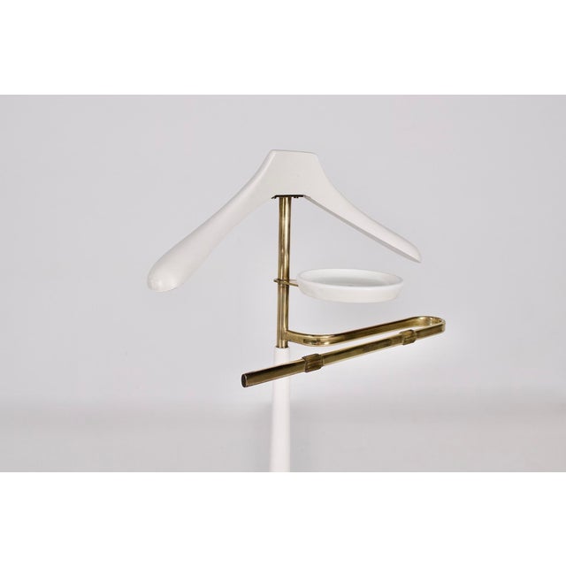 Turned wood and solid brass valet stand, base covered in white faux leather, from the Vereinigte Werkstätten München, late...