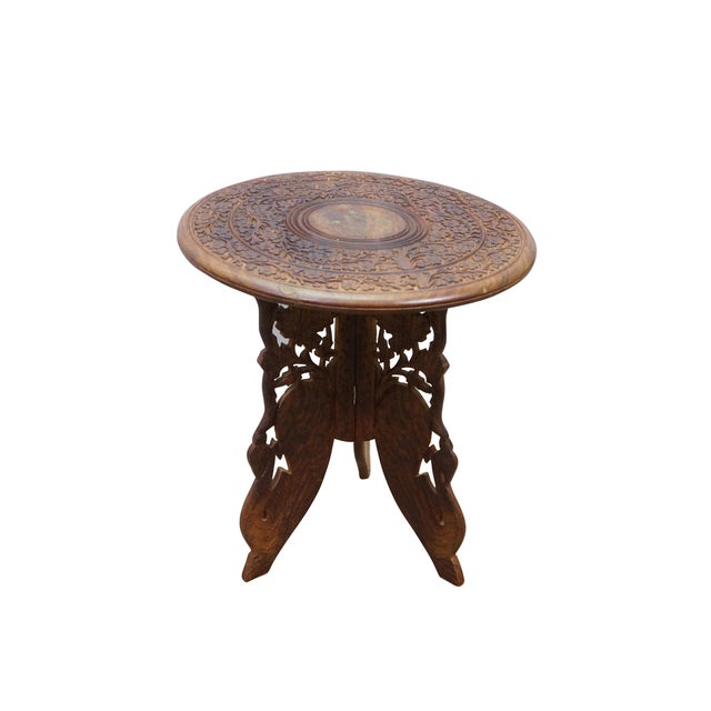 Vintage Anglo-Indian carved teak folding tripod pedestal plant stand table featuring a reticulated floral design and brass...