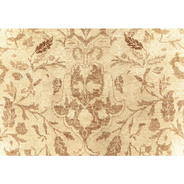 An early 20th century antique Tabriz rug from Northwest Persia, the sand field with floral sprays around a central...