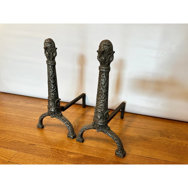 A beautifully detailed pair of antique cast iron andirons (or firedogs) made by The Ohio F & M Co., an Ohio foundry active...