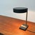Minimalist mid-century table lamp by Hillebrand. A minimalist design in shape and color. The shade is round. The base is a...