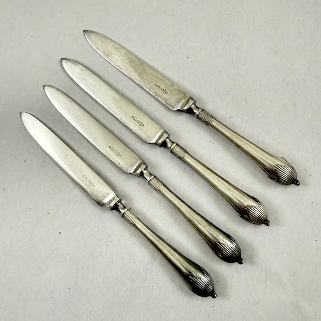 A set of four silver plate fruit or dessert knives, showing the hallmarks for Walker & Hall, Sheffield, England circa...