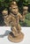Vintage sculptural candelabra featuring a seated monkey holding two candle cups. The figure has a detailed fez hat, vest,...