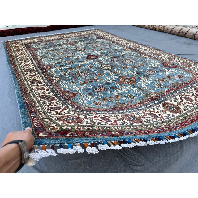 This elegant Sultanabad rug presents an open, allover composition of scrolling vines and palmette rosettes in rust, ivory,...