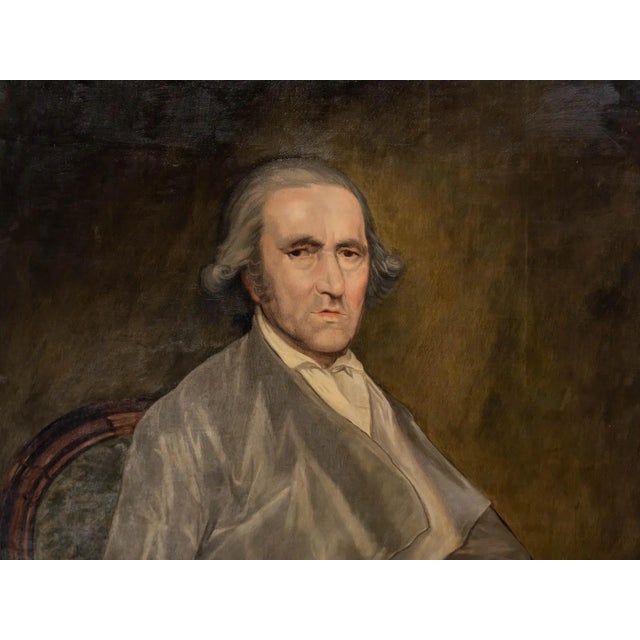 Painted canvas depicting a seated man with a paintbrush in hand.