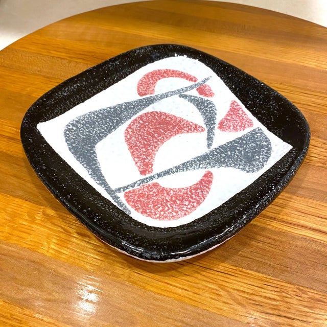 A fantastic ceramic atomic style plate with black and gray and pink boomerangs. The square plate has rounded edges. Marked...