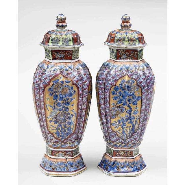 Pair of very finely decorated Chinese blue and white clobbered vases and lids. The neck and base are hexagonally shaped,...