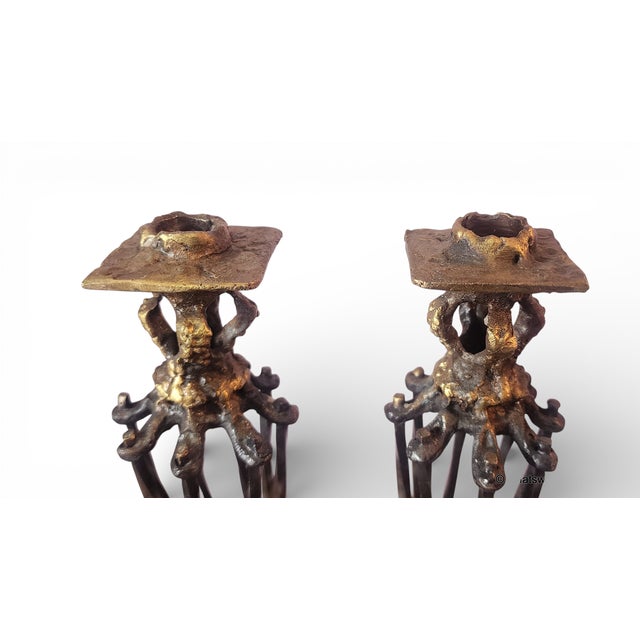 This is a rare pair of Chaim Hendin bronze brutalist Jewish Judaica ceremonial candlesticks on base platform, c1970s....