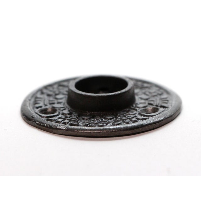 Cast iron Aesthetic style door rosette with a black finish. Priced each. The dimensions are 2 in. diameter x 0.25 in. D....