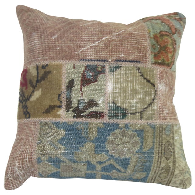 A pillow created from an assortment of vintage Persian, Turkish European and Asian rugs.