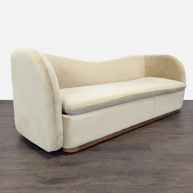 This West Elm 3-seat sofa features a modern curved design and soft beige upholstery. It offers a generous seating area and...