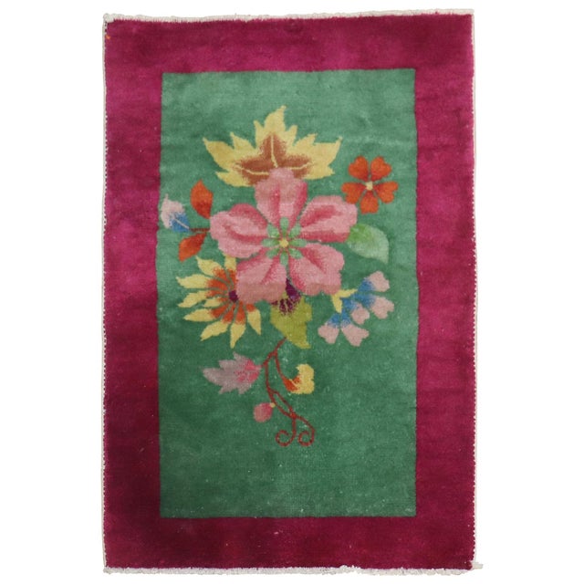 An authentic full pile condition mid-20th century, Chinese Art Deco Mta rug with a large floral design on a green field...
