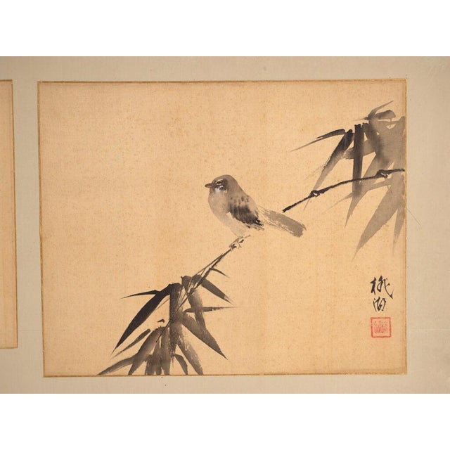 This antique Japanese two-panel screen is a byōbu in harimaze mounting, with pasted ink paintings on the ground. It...