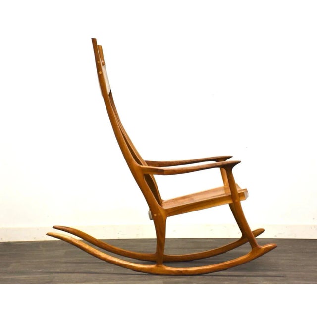 A mid century modern style walnut rocking chair made in the style of Sam Maloof by Jeff Lind. Seat height is 16”. 26.5”...