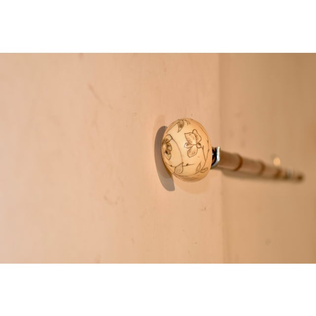 Circa 1930's cane made of fruitwood with a bone handle. The bone handle is etched with a lovely floral pattern. The...