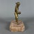 An expressive gilded bronze tabletop figurative sculpture depicting a bocce player, attributed to 20th-century...