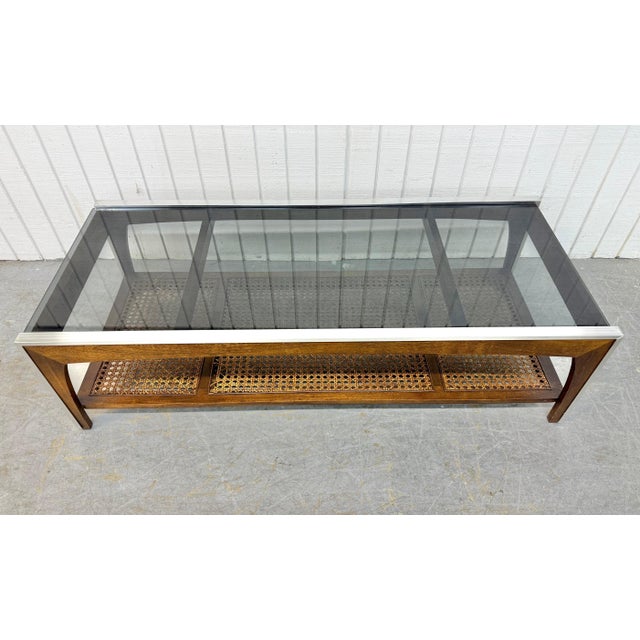 This listing is for a Mid-Century Modern Smoked Glass Coffee Table. Featuring a straight line design, rectangular smoked...