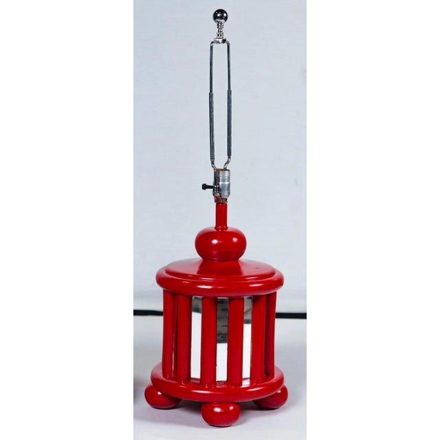 A pair of Mid-Century bright red painted wood lamps with mirrored panels. Height to top of socket: 18.5 inches. Clear...