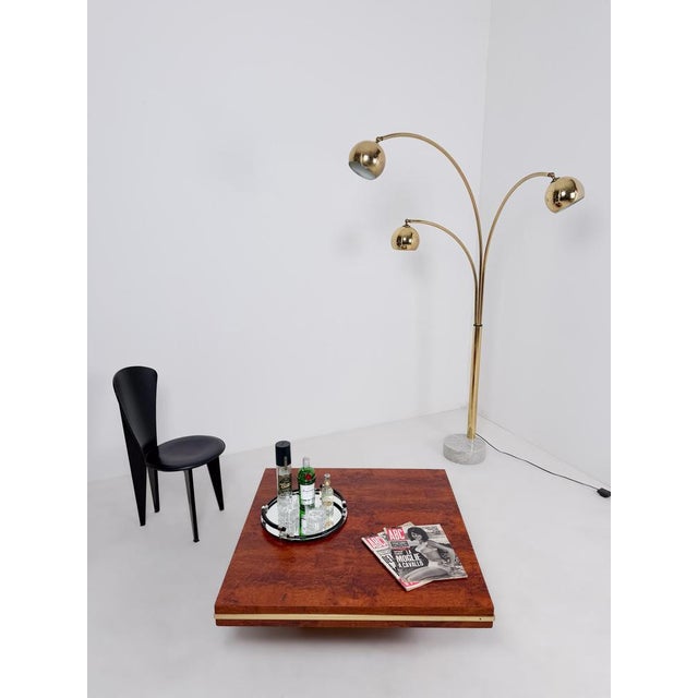 A refined Mid-Century Modern square coffee table, confidently dated to the 1970s, offering a striking yet sophisticated...