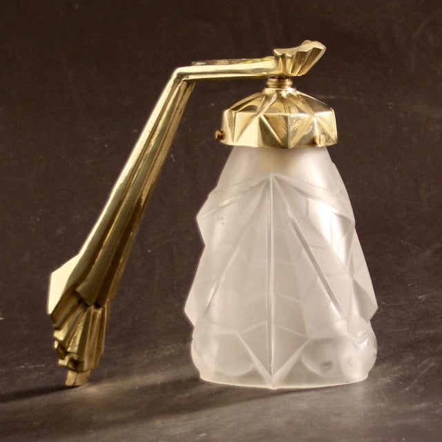 Massive Brass/Bronze fixture and signed shade with geometric At Deco ornaments. - Electric renewed This piece has an...