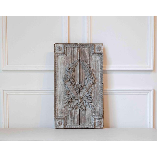 A refined French carved wood panel from the Louis XVI period, dating to the late 18th century. Executed in solid oak and...