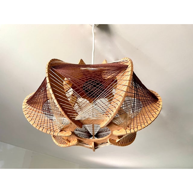 Scandinavian pendant light from the 1970s, lightweight wooden frame with beige and brown taut wires, in very good vintage...