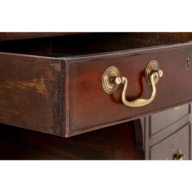 Georgian Revival Mahogany Sideboard. Circa 1890 This Sideboard is of a Bow Form. Raised Upon Tapered Legs with Square Box...