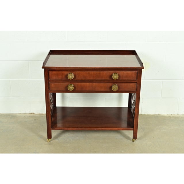 A gorgeous Chippendale or Georgian style rolling buffet server, credenza, or bar cart By Baker Furniture, "Historic...