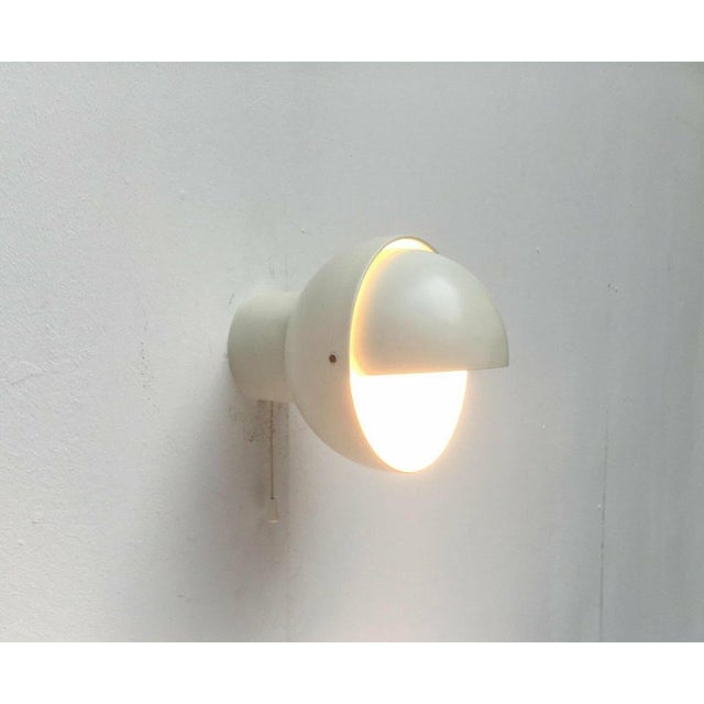 Rare Space Age wall lamp from Raak according to a design by Radboud van Beekum from the 1960s. The basic form of this...