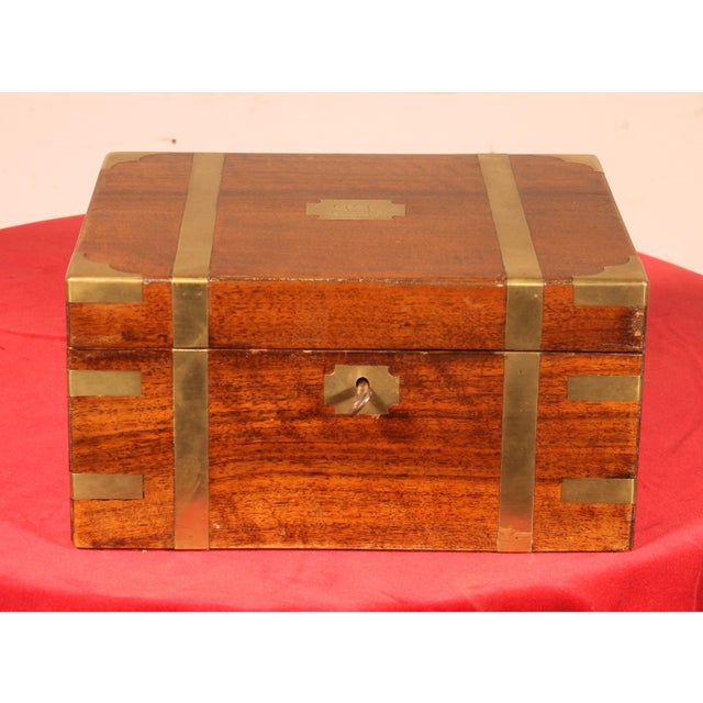 An elegant English naval walnut writing desk with brass decorations typical of this type of furniture. Beautiful brass...