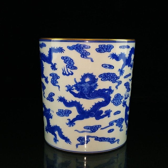 This is an elegant, cylindrical porcelain brush pot (bitong), crafted in the classic Chinese blue and white style. The...
