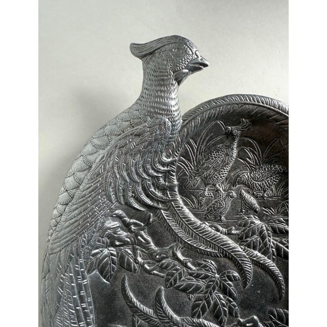 This vintage 1986 sculptural serving tray by Arthur Court features an elaborate double pheasant motif cast in textured...