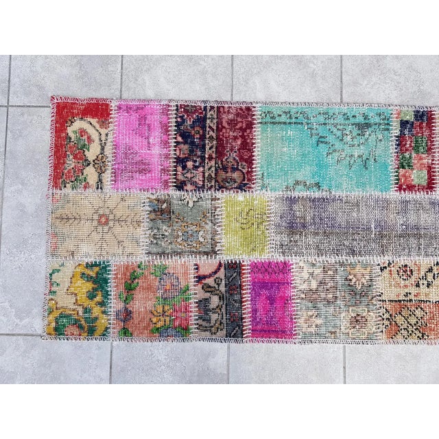 This is a vintage Turkish Oushak rug from the Mid 20th Century. The piece was hand-knotted.