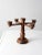 A vintage wooden candelabra with a turned wood form, featuring four arms and a central pedestal. The warm wood tone brings...