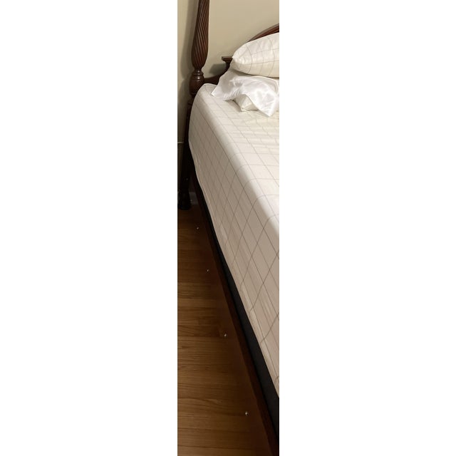 A Pennsylvania House solid wood four poster queen size bed. The headboard and footboard feature spiral turned posts. The...