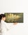 This early 20th century painting from France is an oil on panel, housed in a wood frame. Its signed detailing gives the...