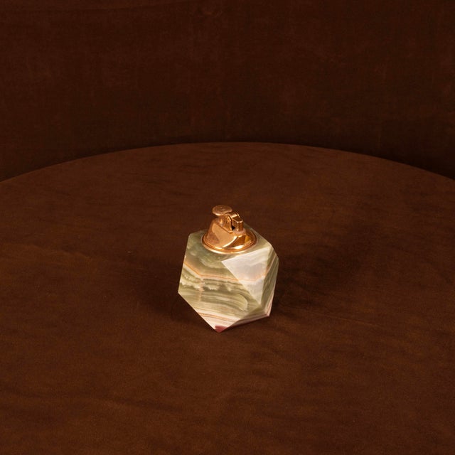 Overview A sculptural table lighter made in Italy during the 1970s, featuring a faceted body carved from richly banded...
