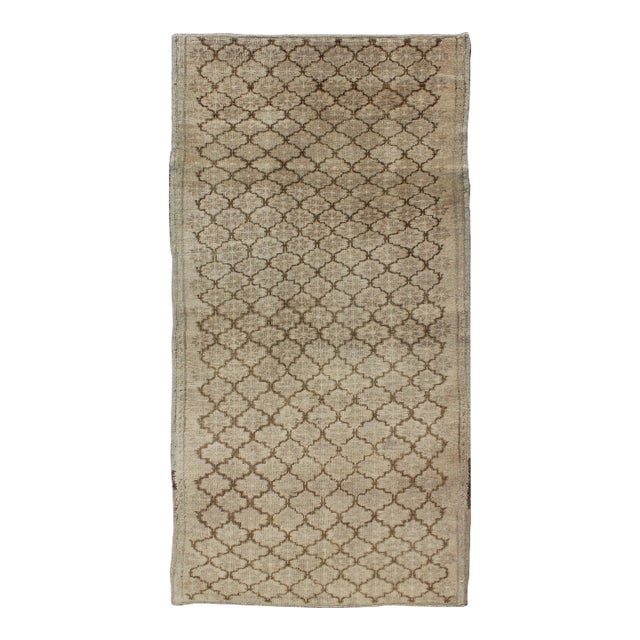 Muted Oushak With All-Over Tribal Design in Light Tones of Taupe and Browns For Sale