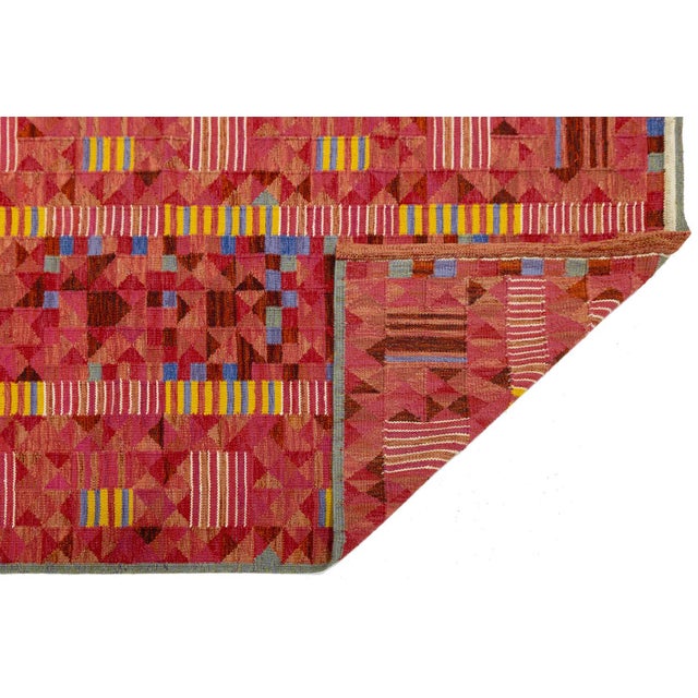 This striking Swedish-style flatweave rug blends mid-century Scandinavian aesthetics with a bold, contemporary color...