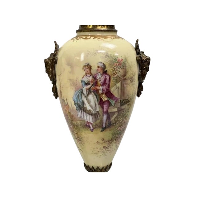 An elegant pair of antique French porcelain covered urns signed A. Daret, exquisitely hand-painted with romantic Rococo...